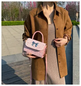 Pink star-patterned handbag with silver bow, small crossbody square bag for women.