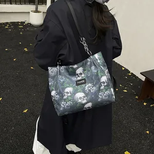 Stylish skull and floral print tote bag for women with elegant chain shoulder strap.