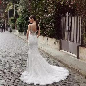 Back view of elegant white lace mermaid wedding dress with spaghetti straps and train