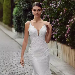 Detailed view of elegant white lace mermaid wedding dress with deep V-neck and floral appliques