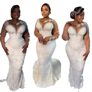 Elegant African mermaid wedding dress with intricate pearl beading and lace long sleeves.