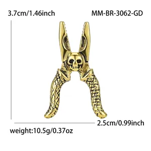 Broche créative en forme de pince dorée avec crâne montrant dimensions et poids