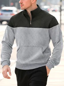 Close-up detail of a men's two-tone quarter-zip sweatshirt with quilted black chest panel