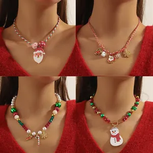 Close-up of four festive Christmas necklaces with Santa Claus and snowman charms
