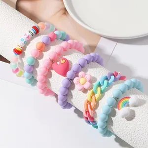 Detailed view of colorful beaded bracelets with heart, flower and rainbow charms