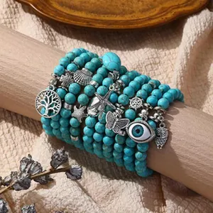 Set of bohemian turquoise bead bracelets featuring tree of life and evil eye charms