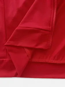 Close-up view of a red men's sports tracksuit showing the zipper and sleeve cuff detail