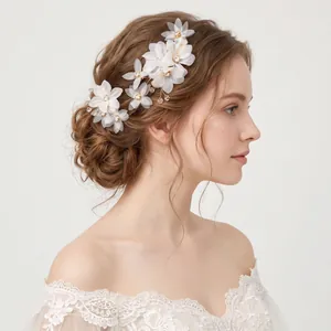 Detailed side view of elegant French fabric flower hairpins on a bridal hairstyle