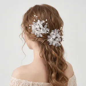 Elegant bridal hairpins with white fabric flowers and pearls for wedding hairstyles