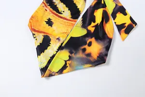 Detailed view of the vibrant butterfly wing print on a halter neck top and skirt set