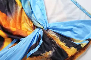 Close-up view showing the intricate twisted knot detail on a vibrant printed halter neck top