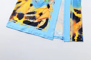 Macro detail of a vibrant butterfly print hem on a stylish summer slit skirt garment
