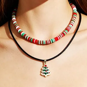 Close-up of layered Christmas tree pendant necklace and colorful beaded choker.