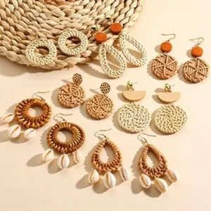 Bohemian handmade straw woven earrings set with natural shells and wooden accents
