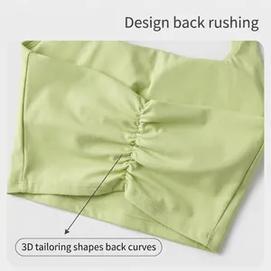 Close-up view of the ruched back detail on a light green seamless sports yoga bra