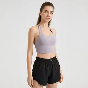Professional studio shot of a model in a lavender halter sports bra and black shorts