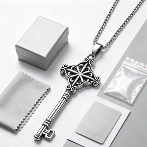 Close-up of vintage stainless steel key pendant necklace with gift box and cleaning cloth