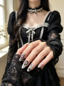 Close-up detail of Halloween nail art stickers featuring cute ghosts and spider webs
