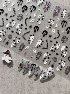 Detailed macro shot of Halloween nail stickers with ghost and spider web designs