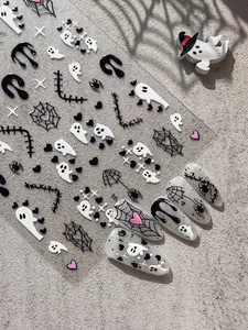 Macro detail view of Halloween ghost nail stickers with spider web and heart patterns