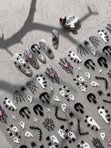 Detailed view of Halloween nail stickers featuring ghosts, spider webs and black drips