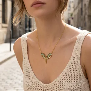 Elegant gold wings necklace featuring micro-pave multi-color cubic zirconia worn by a model