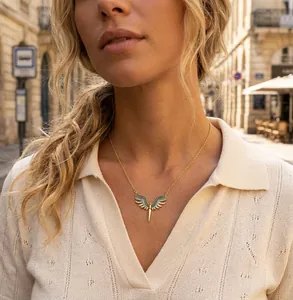 Detailed view of an elegant wing pendant necklace with micro-pave zirconia on a gold O-chain