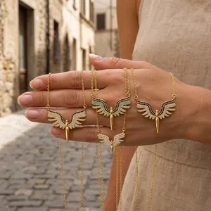 Close-up detail of four gold wing necklaces with micro-pave cubic zirconia accents