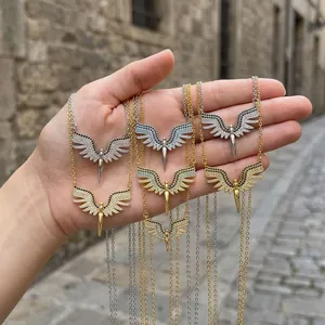 Close-up of various wing shaped necklaces with micro-paved zircons in gold and silver finish.