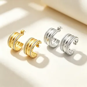 Detailed view of elegant C-shaped stainless steel hoop earrings with four-row crystal pave.
