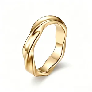 Close-up detail of a gold Mobius titanium steel ring with an elegant twisted design.