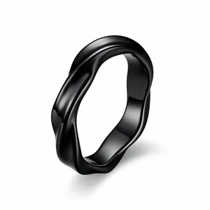 Detailed close-up view of a minimalist black Mobius twisted ring with a smooth matte finish