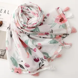 Elegant white floral scarf with cotton-linen feel featuring silver thread and pink tassels