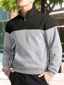 Detailed view of a men's color-block half-zip sweatshirt featuring a quilted texture.