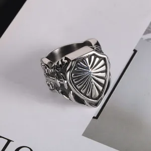 Vintage style men's stainless steel shield ring with detailed sunburst pattern engraving