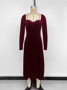 Detail view of an elegant burgundy velvet long-sleeved midi dress on a mannequin