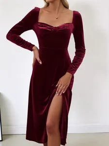 Close-up of an elegant burgundy square neck velvet midi dress with a side slit detail