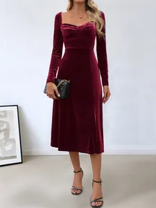 Elegant burgundy velvet midi dress with square neck, long sleeves, and side slit detail.