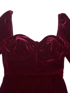 Detailed macro view of wine red velvet dress bodice featuring elegant square neck design
