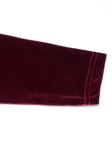 Close-up of wine red velvet dress sleeve cuff with double stitching detail