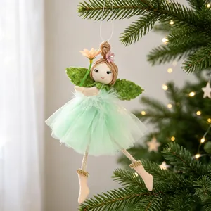 Handmade fairy angel doll ornament with green tulle skirt on a festive tree branch