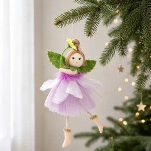Close-up of a handmade fairy angel ornament with purple tutu skirt hanging on a tree