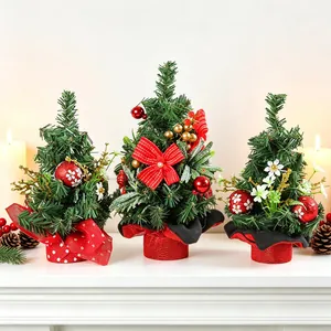 Set of three mini decorated Christmas trees with red bows and berries on a white mantel