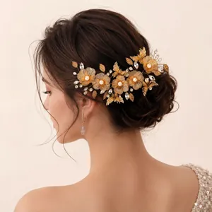 Elegant gold floral bridal hairpiece with crystals and pearls for wedding hairstyles.