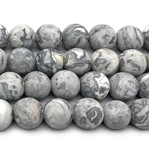 Detailed close-up of natural matte map stone round beads with gray and white stripes