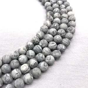 Close-up of matte natural map stone beads with unique grey marbled patterns