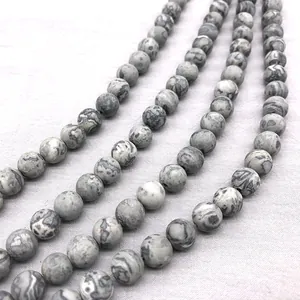 Macro view of matte natural map jasper beads with unique grey and white stripe patterns.