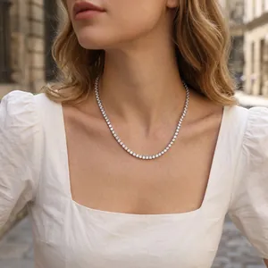 Detailed shot of a sparkling zircon tennis chain necklace on a female model.