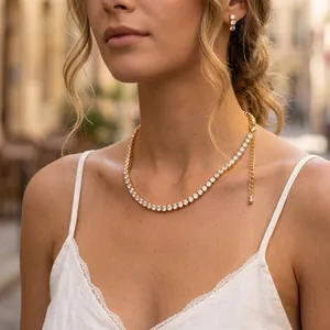 Elegant gold-plated tennis necklace with sparkling zircons worn by a model outdoor