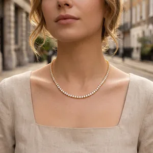 Close-up of an elegant gold-plated tennis necklace with sparkling round CZ stones